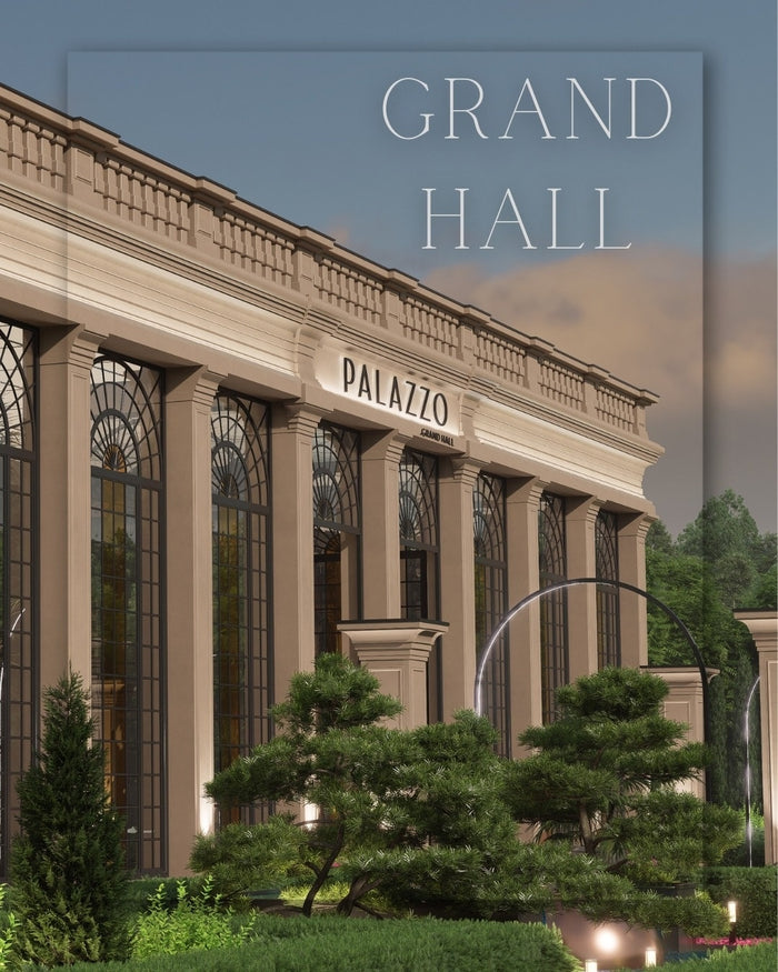Fațada iluminată a clădirii Palazzo Grand Hall noaptea, cu coloane clasice și copaci bonsai la intrare.